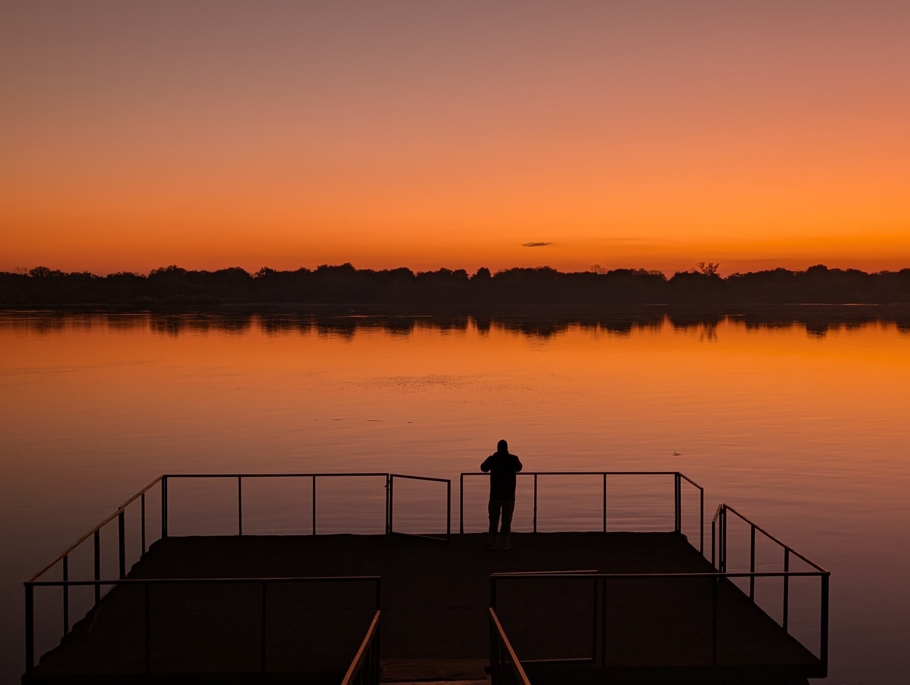 Kevin enjoying the Sunday morning sunrise (6:10am or so) on the Zambezi river, looking across to Zambia. The Zambezi is the 4th longest in Africa; our lodge is situated at a narrow spot in the river that was used as a ferry crossing in the late 19th century colonial era.